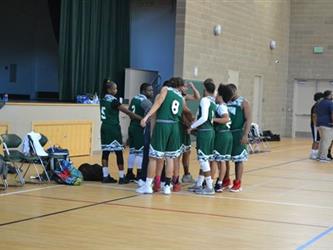 Vista Nueva Boys Basketball Team huddle.