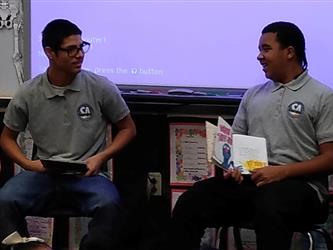 Two Student Alliance students share in reading to a class.