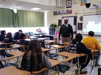 Mr. Brown speaks to students in Ms. Hamiltons class.