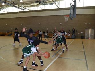 Vista Nueva boys playing in basketball game.